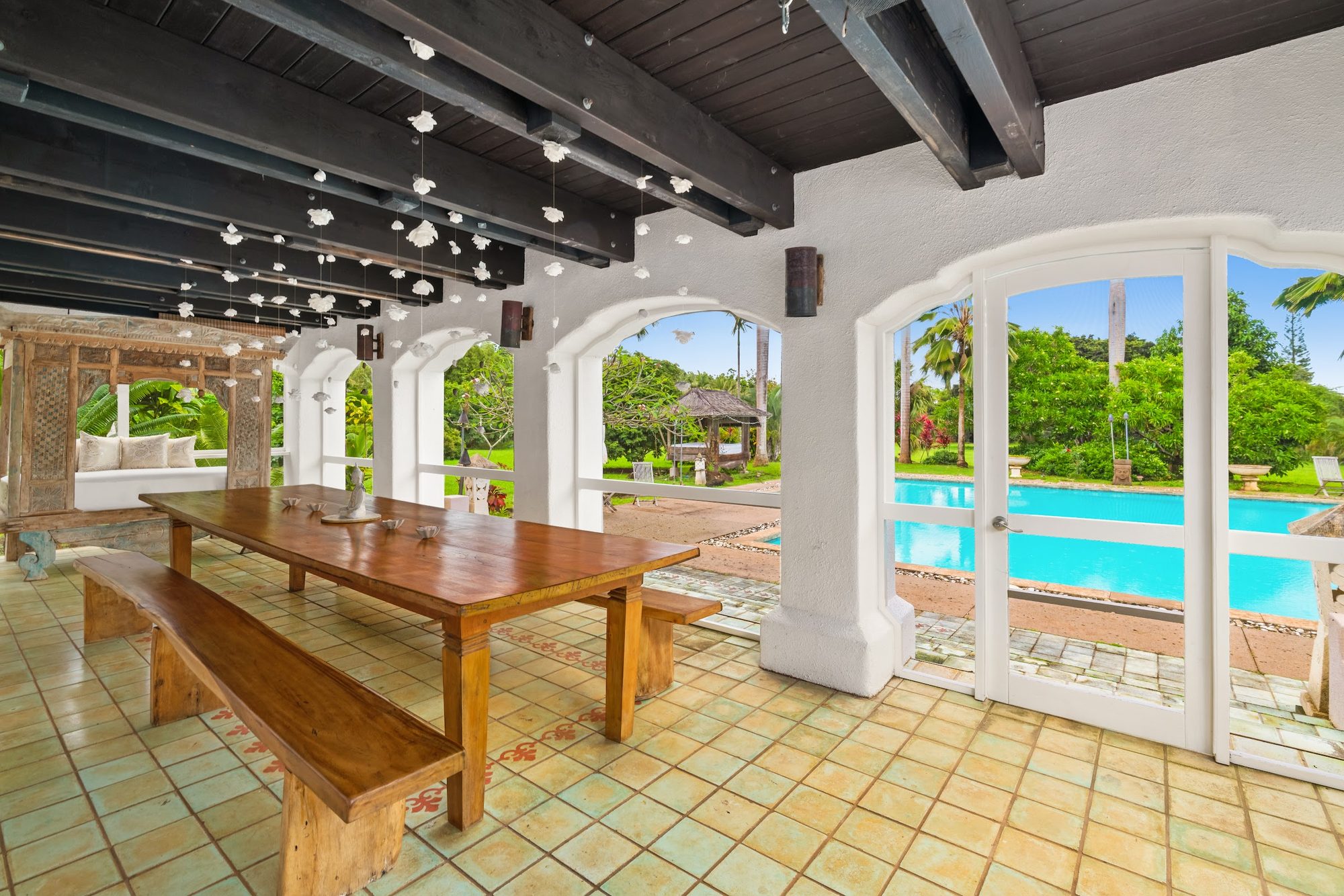 Lanai dining with the pool beyond