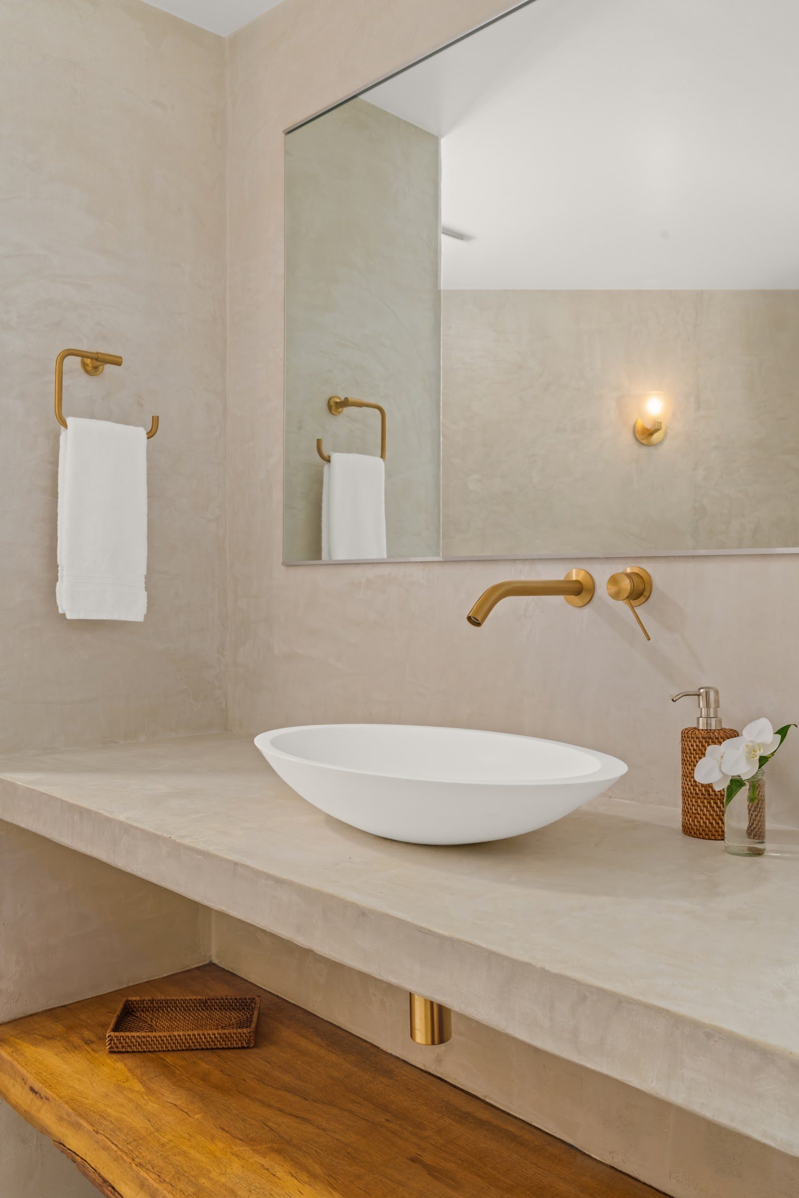 Spa bath with stone basin and timber vanity